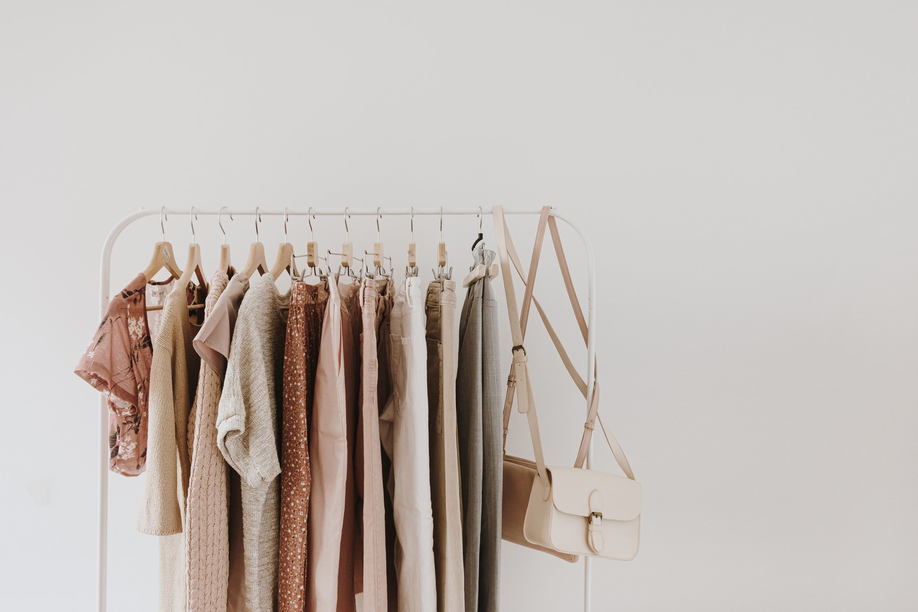 Clothes and Bags Hanging on a Rack